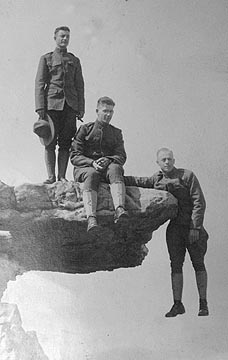 soldiers on rock ledge one dangling